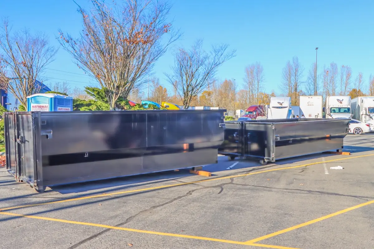 Professional dumpster rental service with roll-off container on residential driveway in Lockport